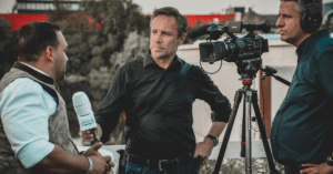 Camera crew interviewing a man.